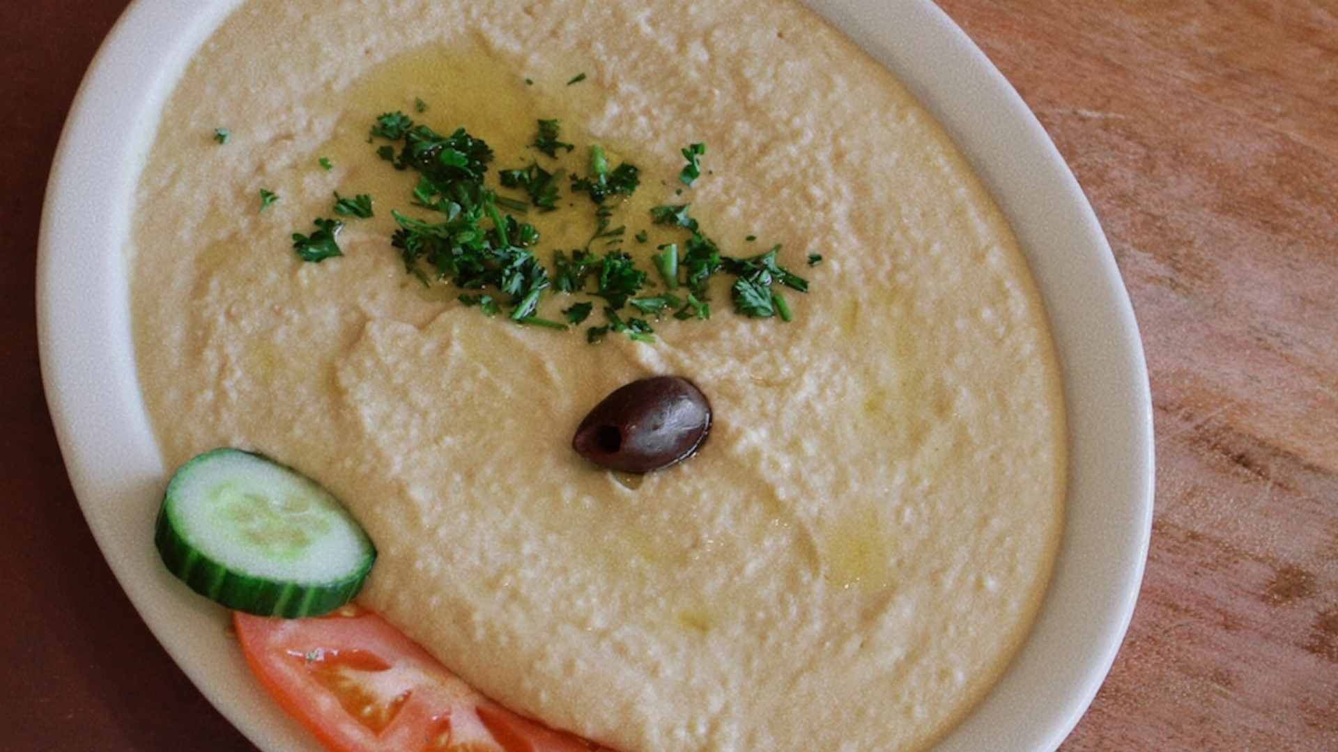 a bowl of hummus with vegetables